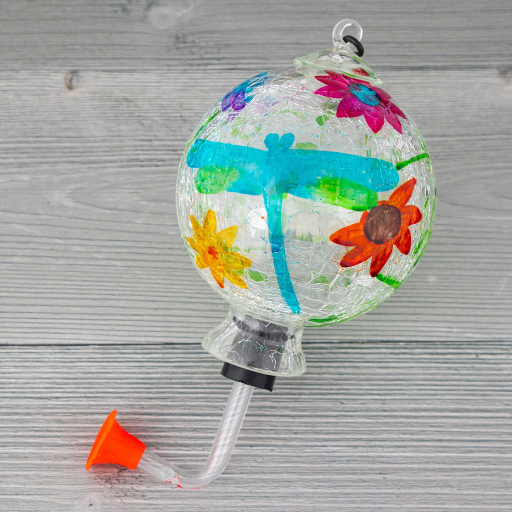 Hanging hand-painted glass hummingbird feeder with colorful flowers and blue-green swirls