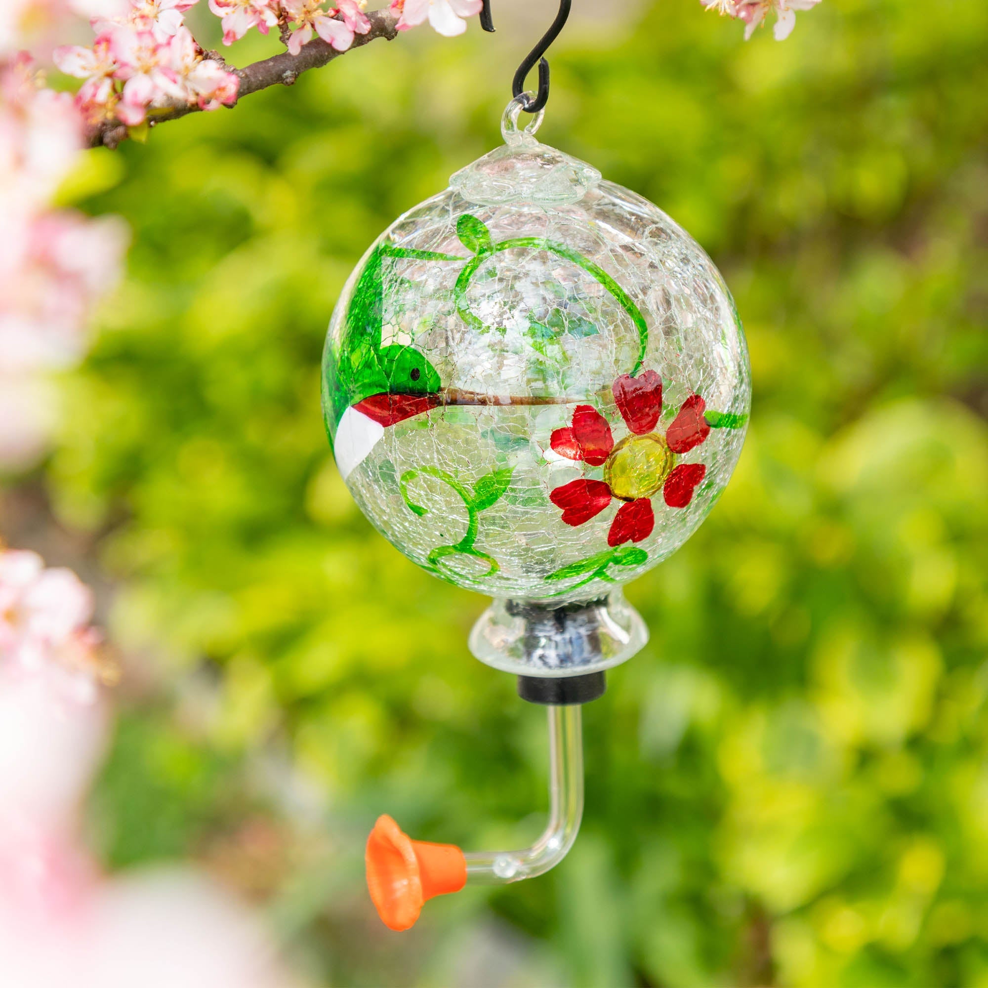 Hand-painted glass hummingbird feeder with green vines, red flowers, and clear feeding tube