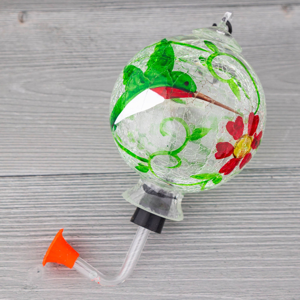 Hand-painted glass hummingbird feeder globe with green bird design, red flowers, clear tube