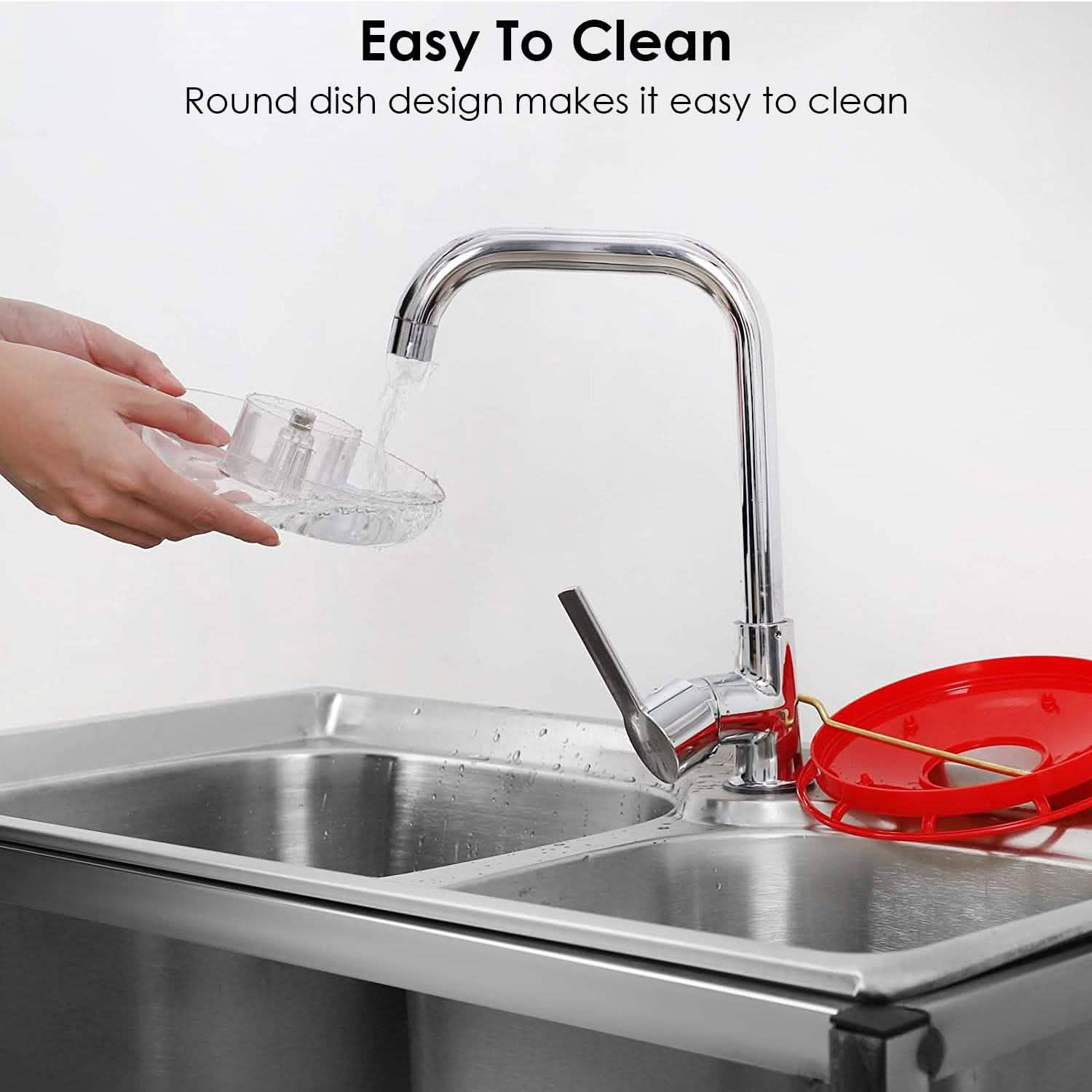 Hummingbird feeder with clear bowl under faucet, red lid, easy-to-clean design