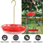 Red hummingbird dish feeder hanging outdoors with hummingbirds around flower ports
