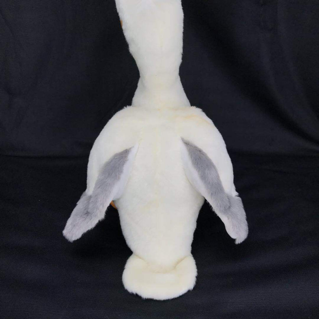 White plush pelican toy with gray wing tips and dangling orange feet, front-facing