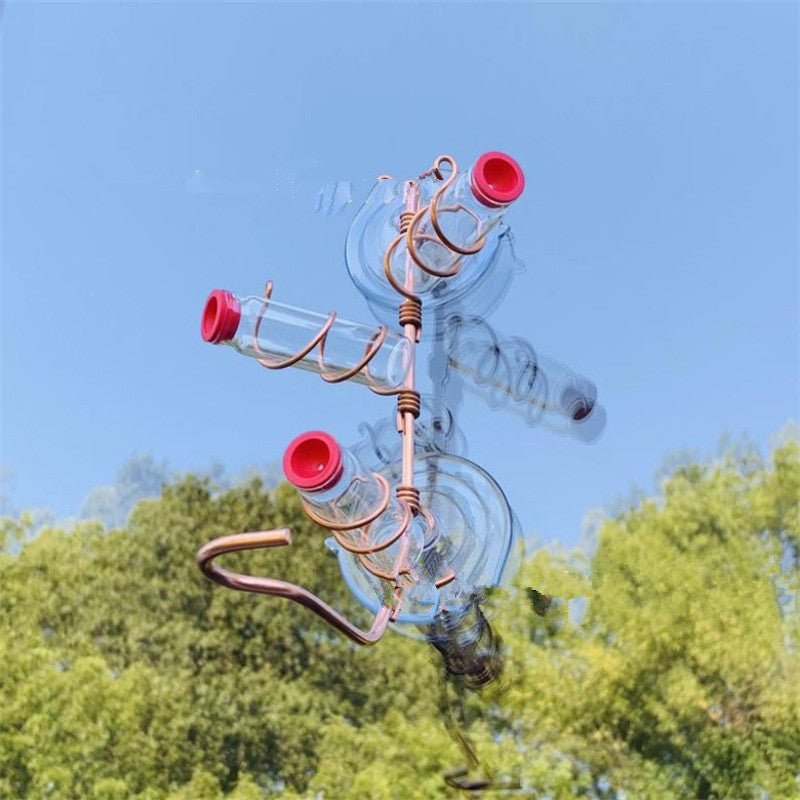 Handmade copper wire hummingbird feeder with clear suction cups and red feeding ports