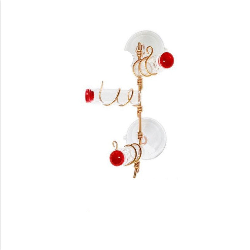 Handmade copper wire window hummingbird feeder with red cups and suction cup reservoirs