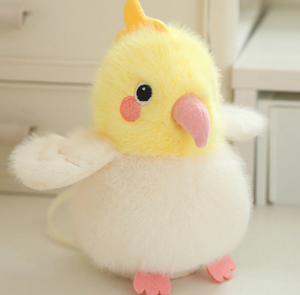 Yellow plush chick bird with pink beak, orange feet, and soft white wings