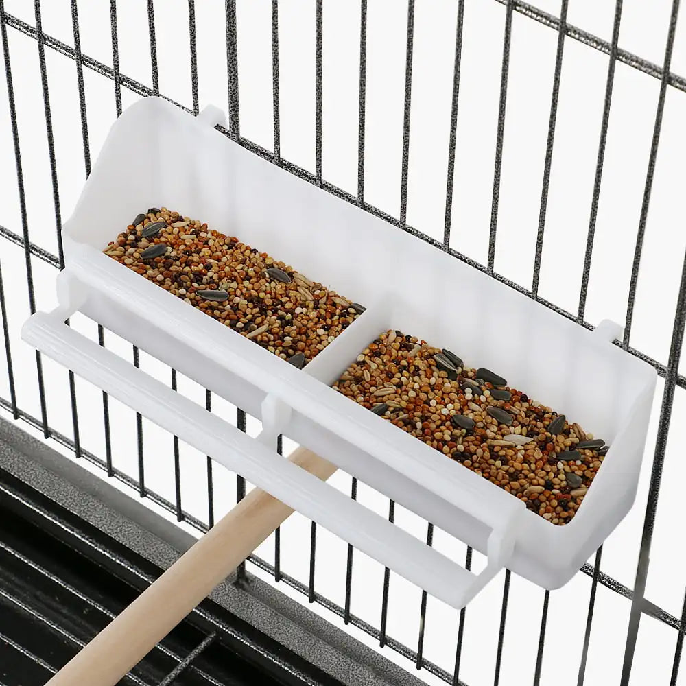 White feeding tray with two seed compartments mounted inside the wire birdcage