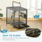 Black metal bird travel carrier with top handle, front door, and bird inside