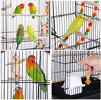 Black bird cage with natural wooden perches and hanging colorful toy ladder