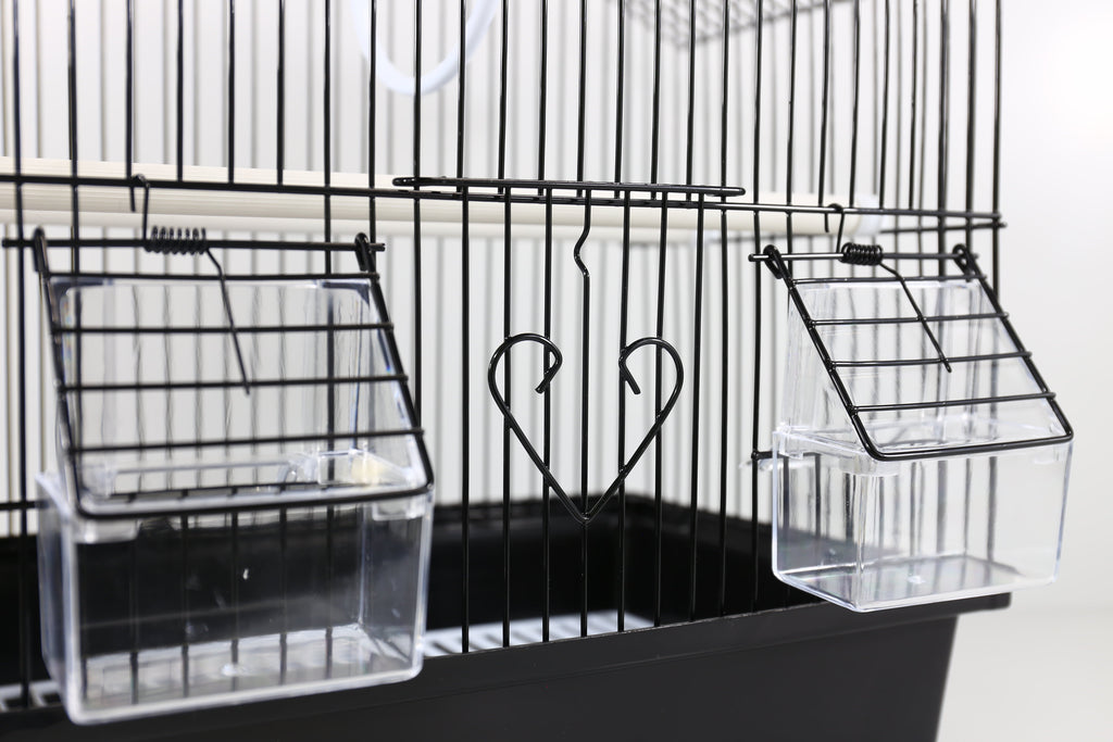 Clear front trays attached to a black wire small bird cage with roof and perches