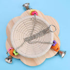 Beige bird nest swing on wooden base with hanging chains, rings, and bell charms