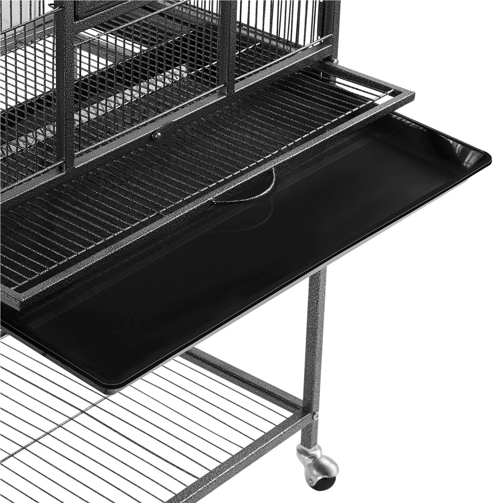 Bird cage top platform with black slide tray and wire grille, on metal frame.
