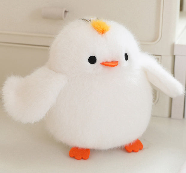 White plush bird with orange beak, orange feet, and small hanging chain