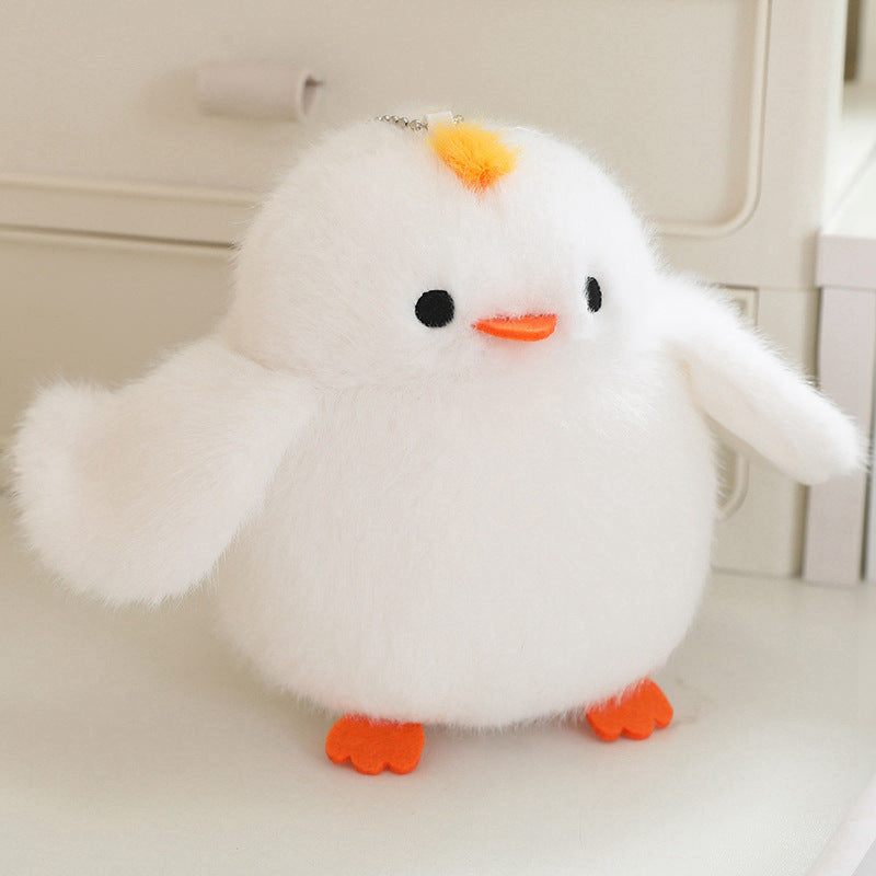 White plush bird with yellow crest and orange feet