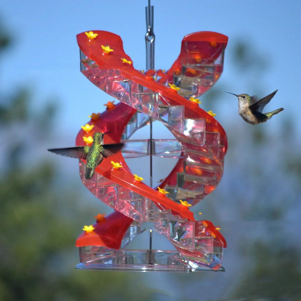 Red spiral hummingbird bird feeder with clear feeding trays and yellow flower accents