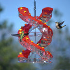 Red spiral hummingbird bird feeder with clear feeding trays and yellow flower accents