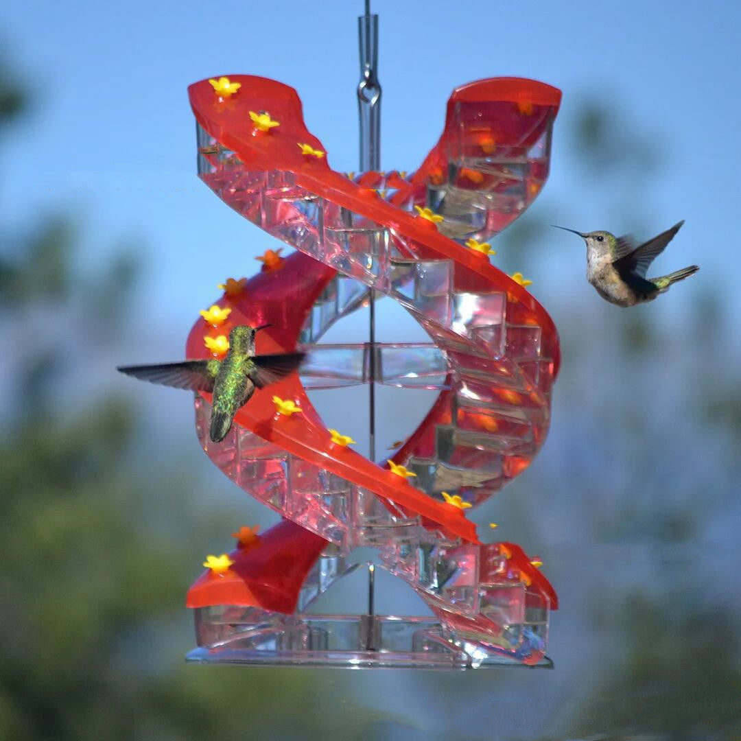 Red spiral hummingbird bird feeder with clear feeding trays and yellow flower accents