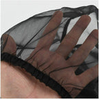 Black nylon mesh seed catcher skirt in hand, gathered elastic edge