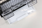 Clear plastic tray under a black wire small bird cage, viewed from above