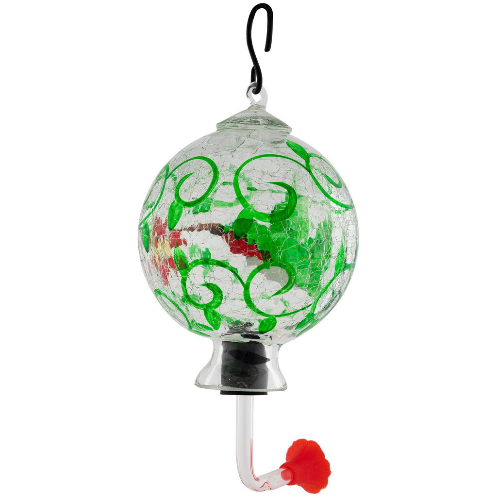 Hand-painted glass hummingbird feeder with green scrolling pattern and red accents