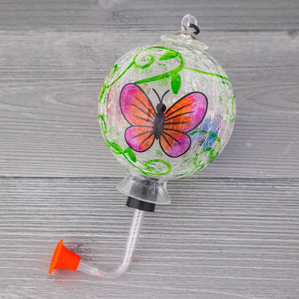 Hanging hand-painted glass hummingbird feeder with butterfly and green vine pattern