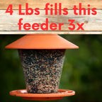 Orange tube bird feeder filled with mixed wild bird seed