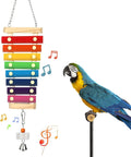 Hanging wooden xylophone toy with colorful bars and bell charms, parrot perched nearby