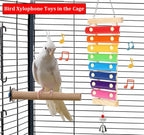 Wooden bird xylophone toy with colorful bars hanging in cage, with white cockatoo