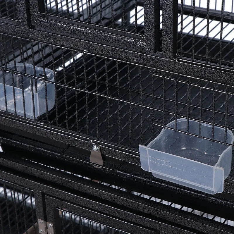 Black wrought iron bird cage close-up of divider bars and sliding bottom tray