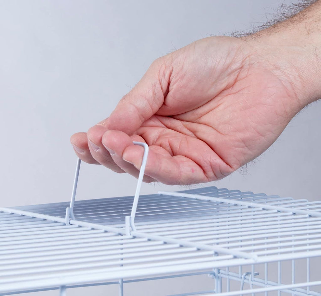 Hand gripping the edge of a white wire bird cage lid or door