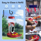 Red hummingbird feeder with solar camera and cleaning setup for easy refill