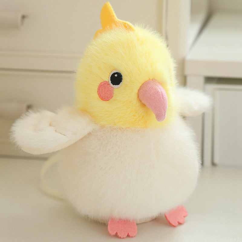 Yellow plush chick with pink beak, orange feet, and soft white wing edges