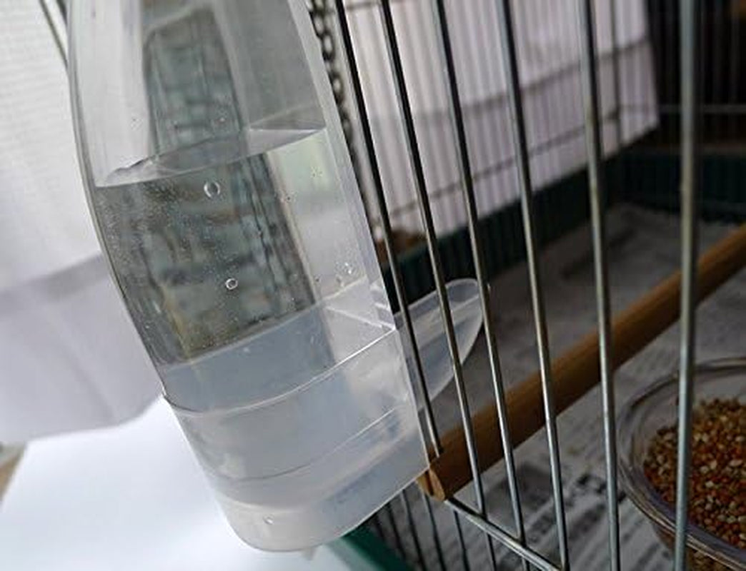 Clear hanging bird water dispenser bottle clipped to cage bars