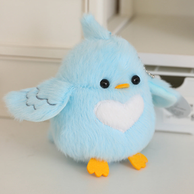 Light blue bird plush with orange feet and yellow beak, white heart belly, 13 cm